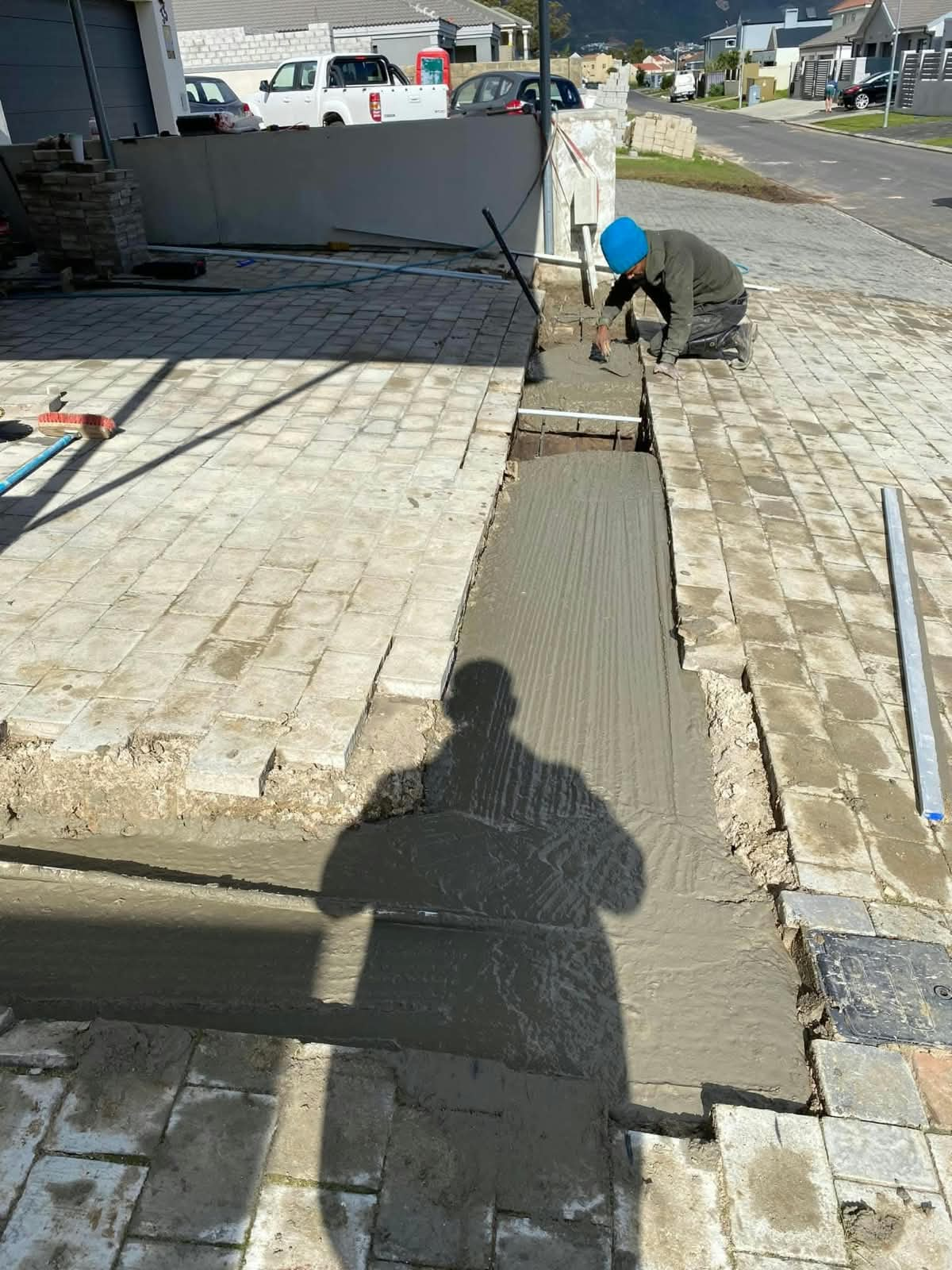 WBS RenCon team laying a concrete strip between paved sections