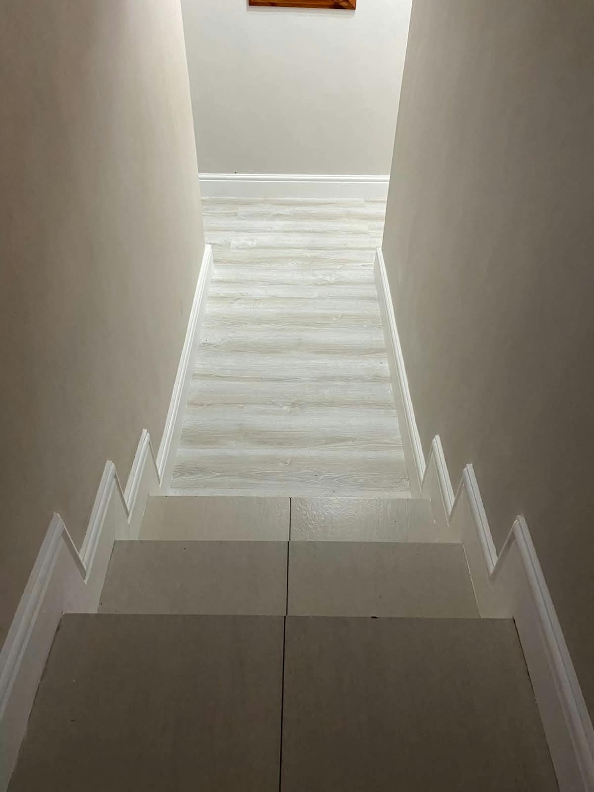 Light wood-look laminate flooring on stairs and landing