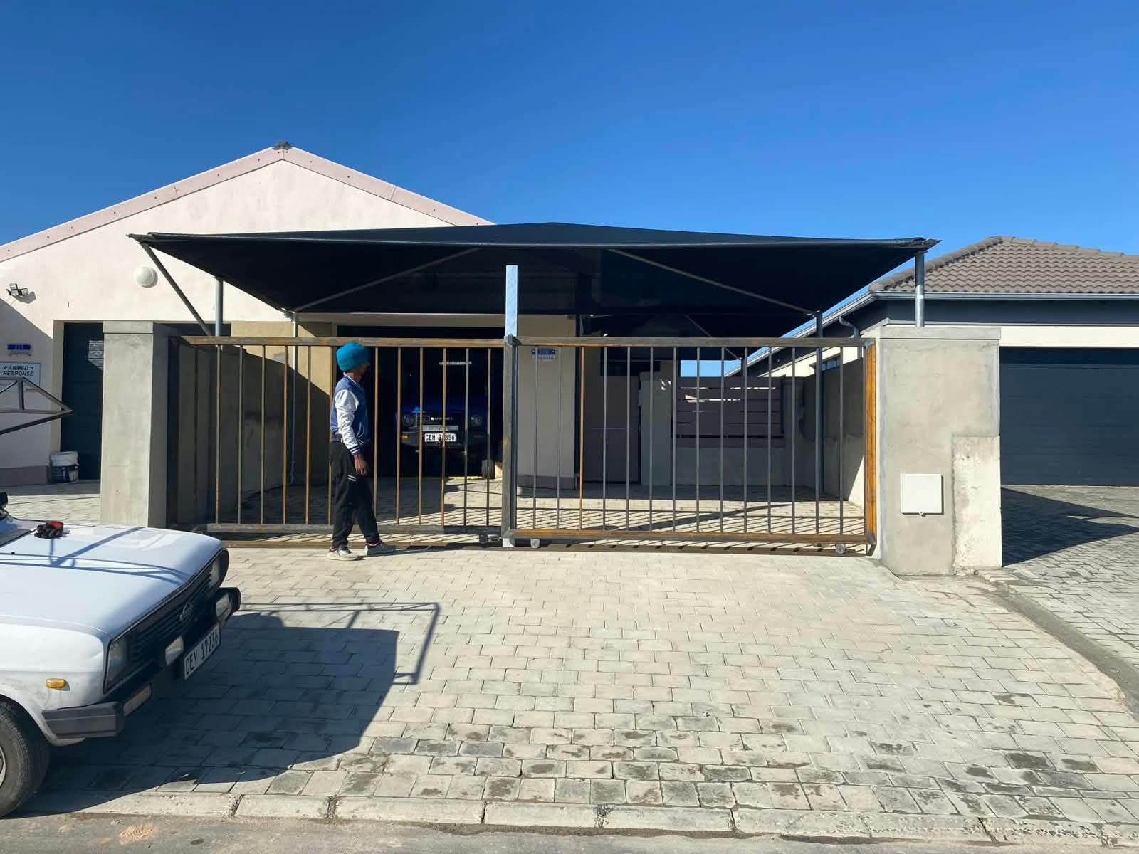 Steel driveway gate frame installed between concrete pillars