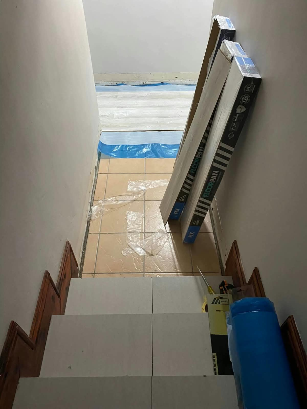 Laminate flooring installation in progress with new boards