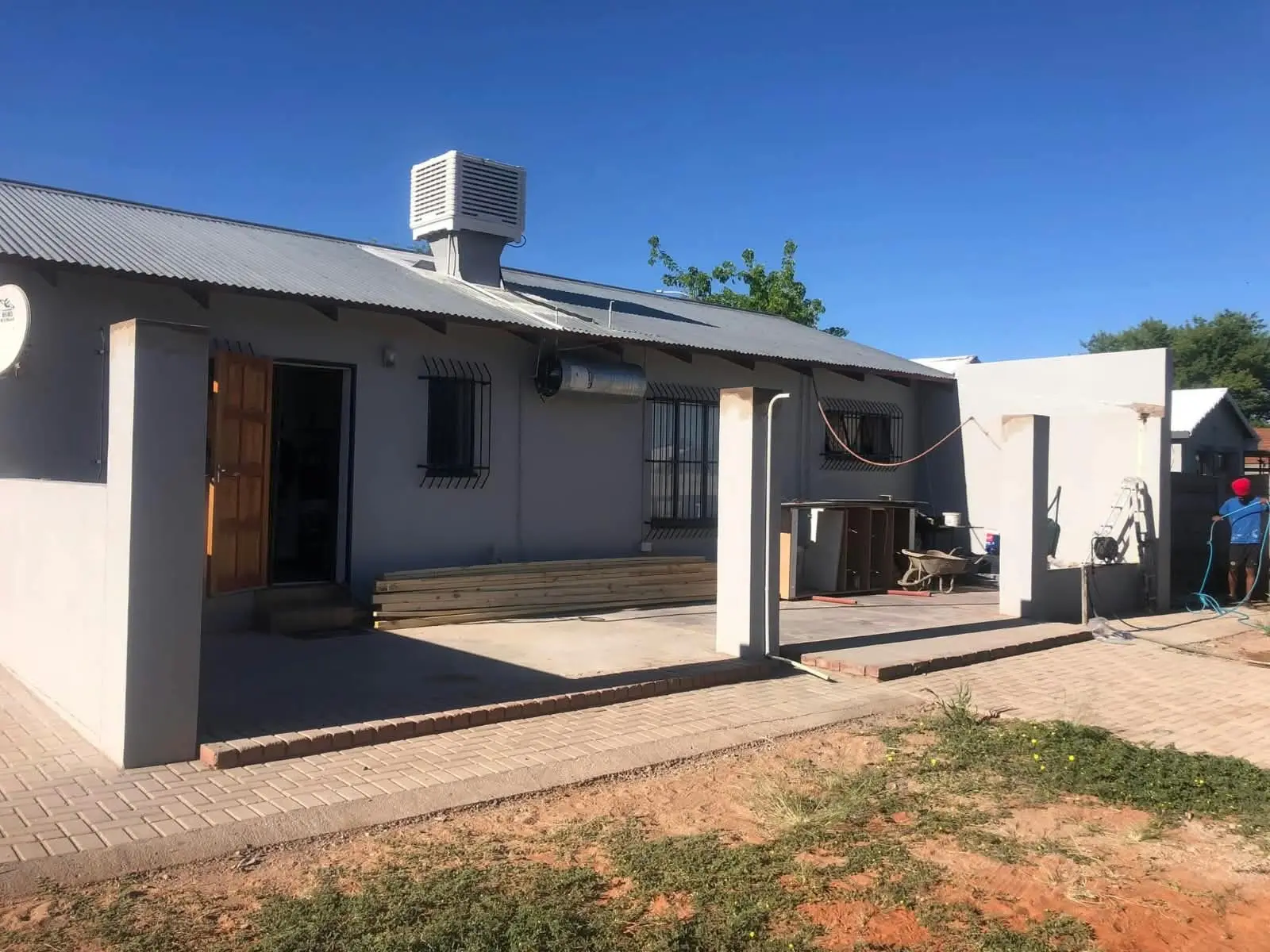 House exterior with paved surrounds and carport columns