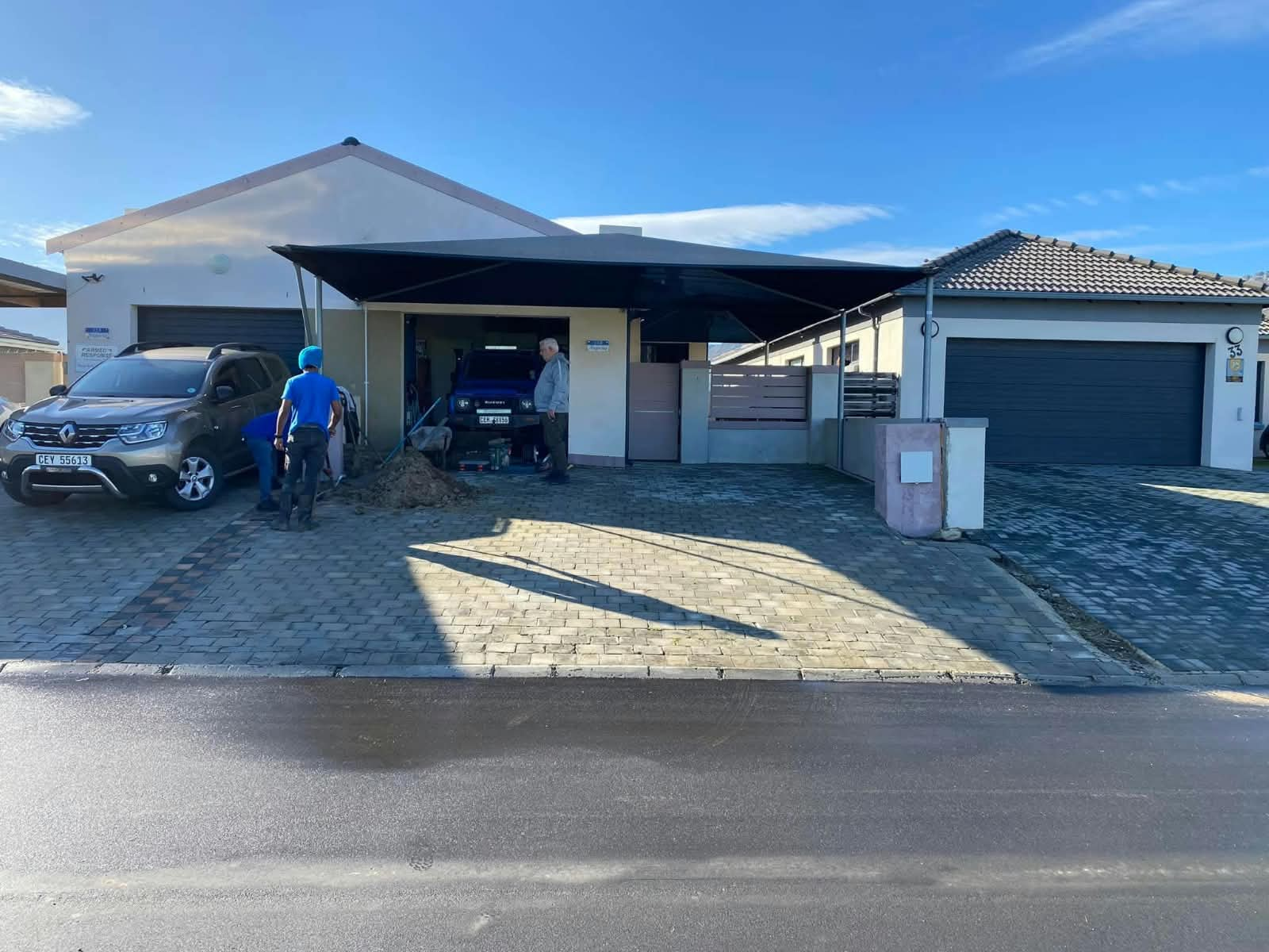 Paved driveway and carport at a Helderberg home during works