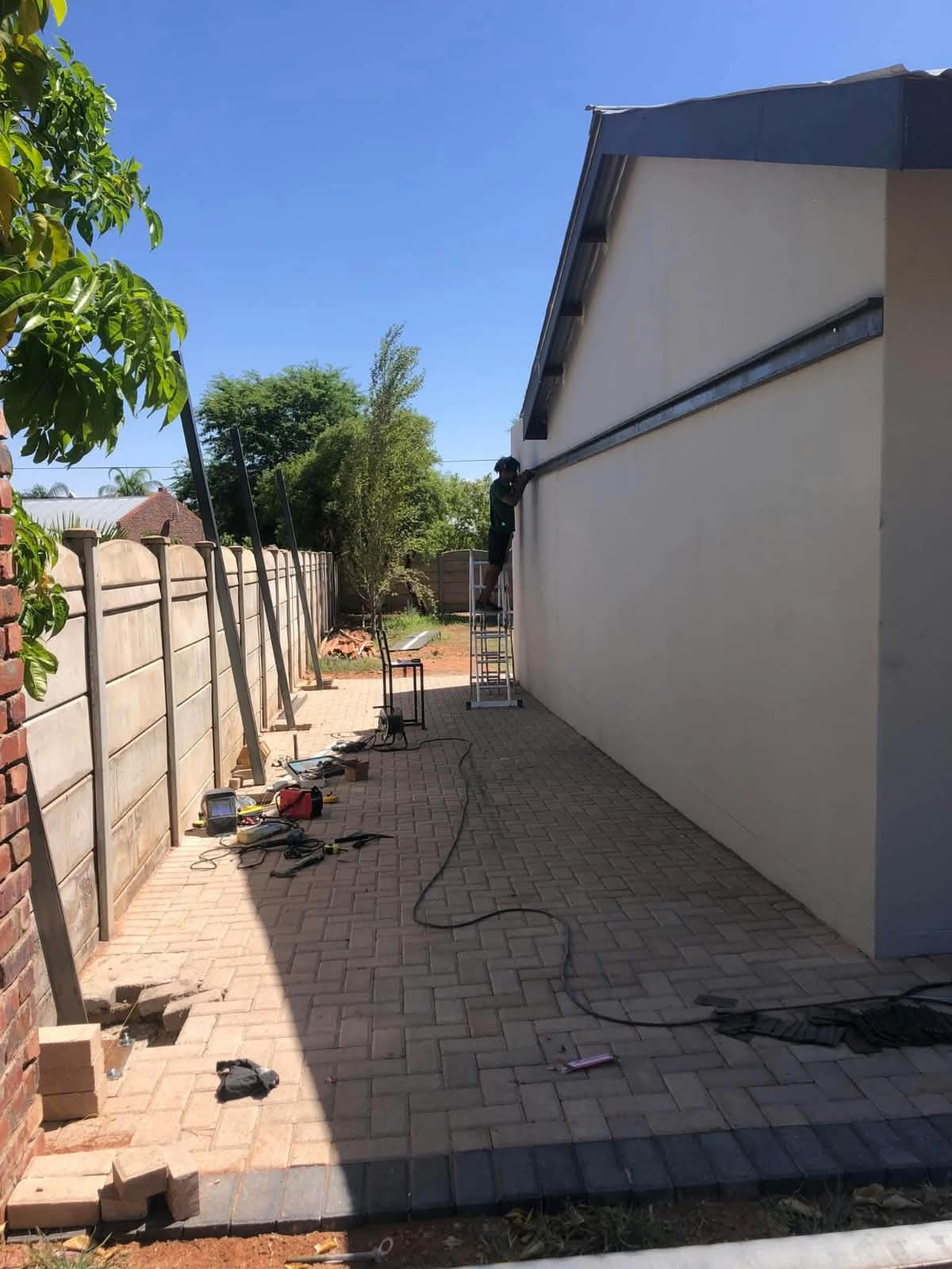 Paved side walkway alongside a boundary wall