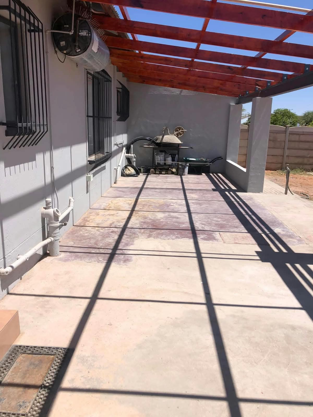 Paved patio area beneath a timber pergola